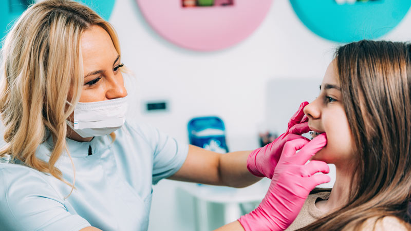 Woman checking childs braces